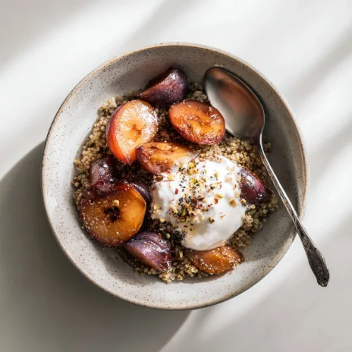 Cinnamon Quinoa Breakfast Bowl with Roasted Plums & Yogurt