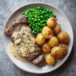 Peppercorn Steak with Garlic Roasted Potatoes and Buttered Green Peas