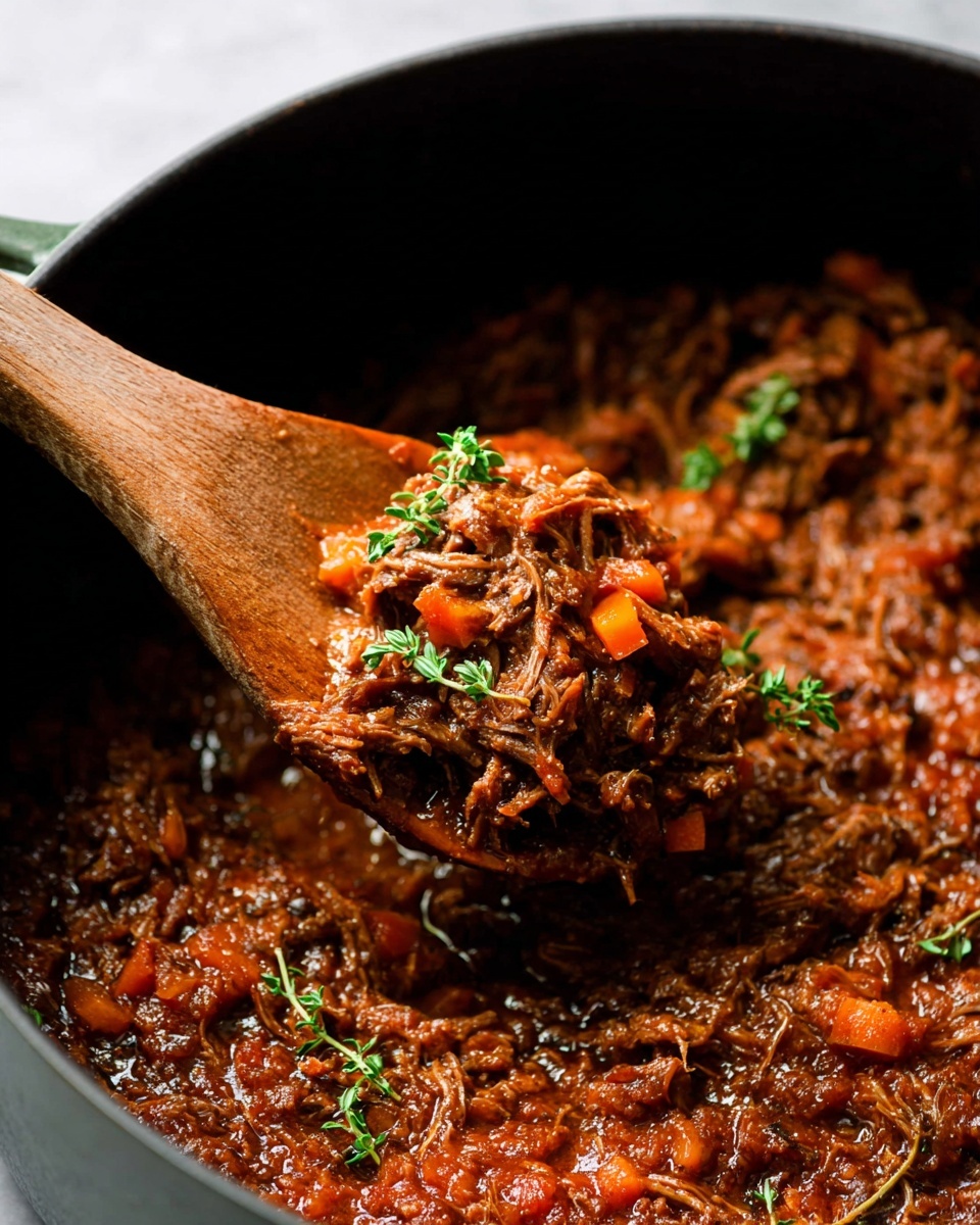 A close-up view of a black bowl filled with wide, flat pasta ribbons coated in a thick, dark brown meat sauce. The pasta is layered in curls and folds, mixed with shredded meat throughout. The top is sprinkled with finely chopped green herbs and grated light-colored cheese. The bowl sits on a white marbled surface, with part of a white cloth visible nearby and a small wooden bowl with more grated cheese in the upper left corner. The overall look is rich and hearty, with warm, earthy tones. photo taken with an iphone --ar 4:5 --v 7
