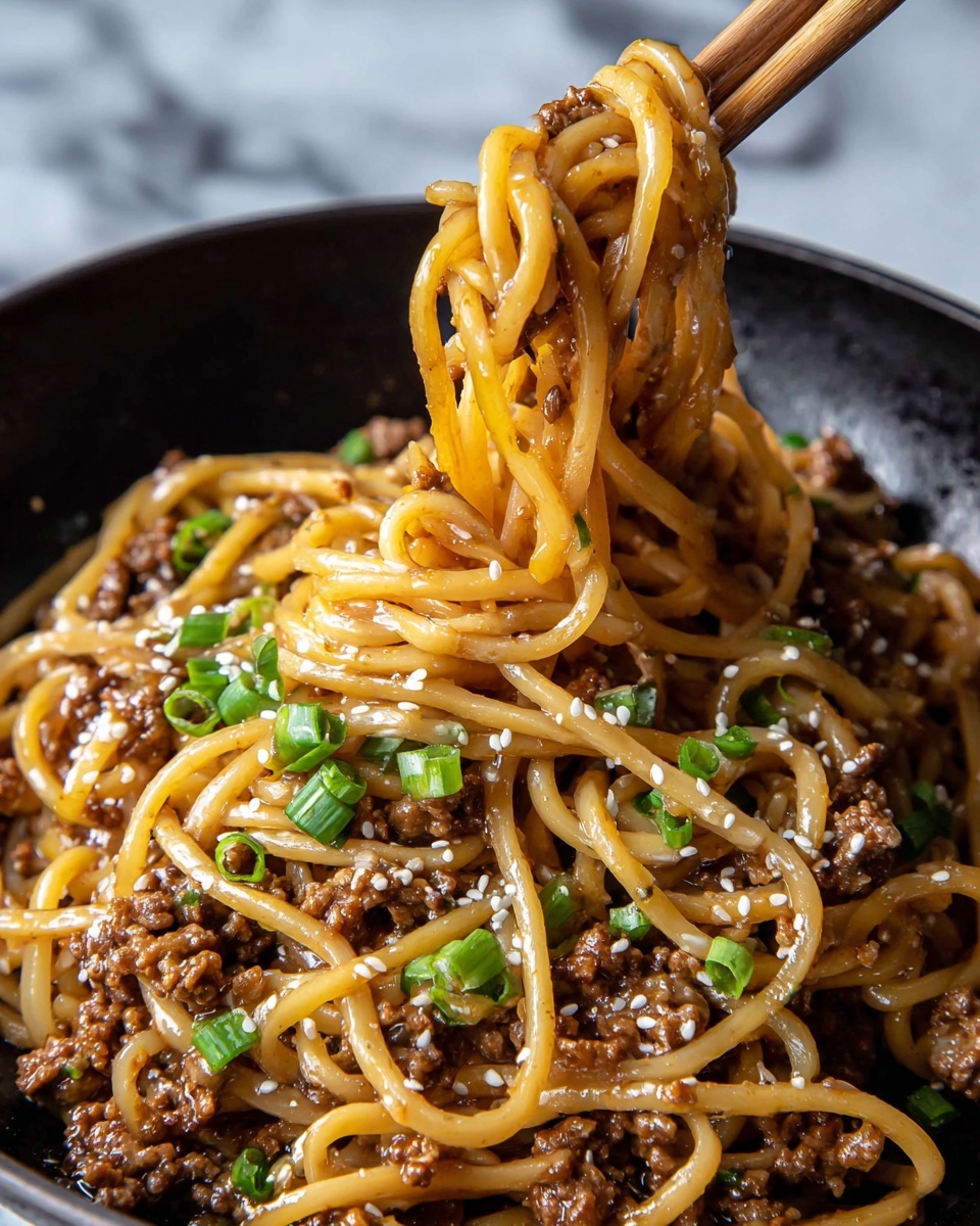 A close-up of a white bowl with blue patterns filled with thick noodles mixed with small brown cooked meat pieces and thin slices of red chili. The noodles look shiny and slightly brown from the sauce, and they are garnished on top with small green chopped spring onions and white sesame seeds. A pair of wooden chopsticks lifts some of the noodles above the bowl. The bowl is placed on a white marbled surface photo taken with an iphone --ar 4:5 --v 7