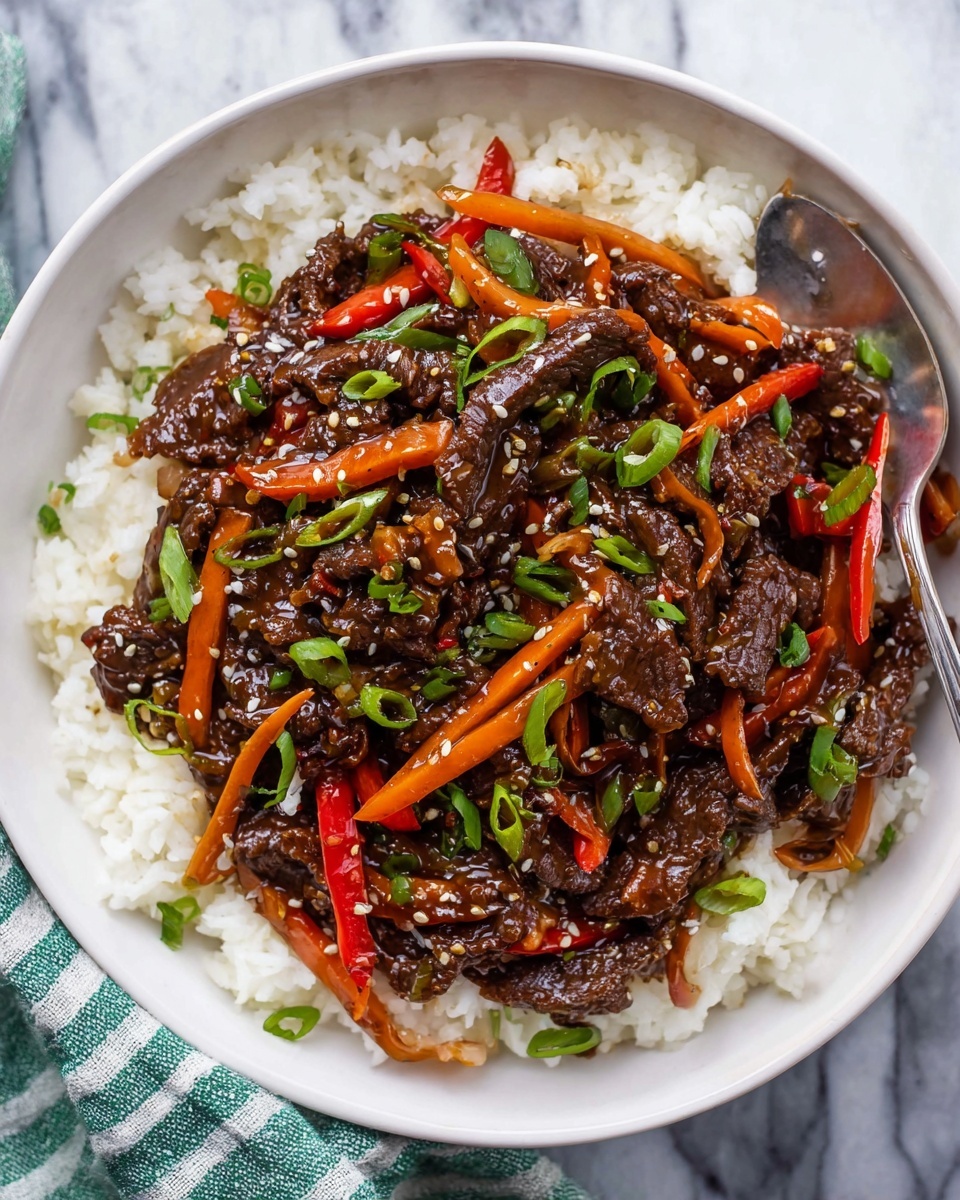 The dish shows a white plate filled with three layers: the bottom layer is plain white rice with soft, separate grains; the middle layer is a pile of dark brown, glossy stir-fried beef pieces, richly coated in sauce; the top layer includes thin strips of bright orange carrots, slices of red chili peppers, and green onion bits scattered all over, along with white sesame seeds sprinkled evenly across; the beef and vegetables have a shiny, slightly sticky texture, contrasting with the fluffy rice beneath. The white marbled surface is visible around the plate edges. Photo taken with an iphone --ar 4:5 --v 7