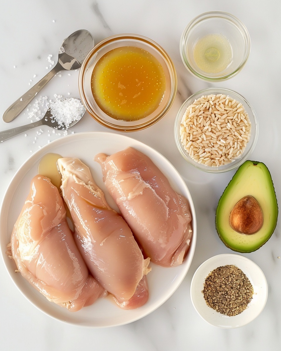 The dish shows three layers on a white plate over a white marbled texture background. The bottom layer is a thick mound of white rice mixed with small green bits of herbs, giving a soft, slightly fluffy texture. The middle layer has four pieces of golden-brown grilled chicken with a shiny glaze, arranged in a row across the rice. The chicken has charred edges and a juicy look. On top, there are two bright green slices of avocado with visible black pepper and chopped herbs sprinkled over all the layers. On the side of the plate, there is a wedge of lime adding a fresh touch. photo taken with an iphone --ar 4:5 --v 7