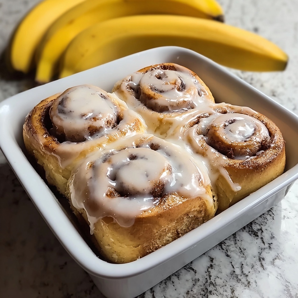 A single cinnamon roll placed in the center of a white floral-patterned plate, showing visible swirls of golden brown dough and darker cinnamon layers inside. The cinnamon roll is generously topped with white, slightly shiny icing that drips down the sides, creating a smooth and creamy texture contrast with the soft pastry. The plate sits on a wooden surface, but for the recreation, imagine it on a white marbled background, enhancing the warm tones of the roll. The lighting is soft and natural, emphasizing the glossy icing and the warm browns of the cinnamon roll photo taken with an iphone --v 7