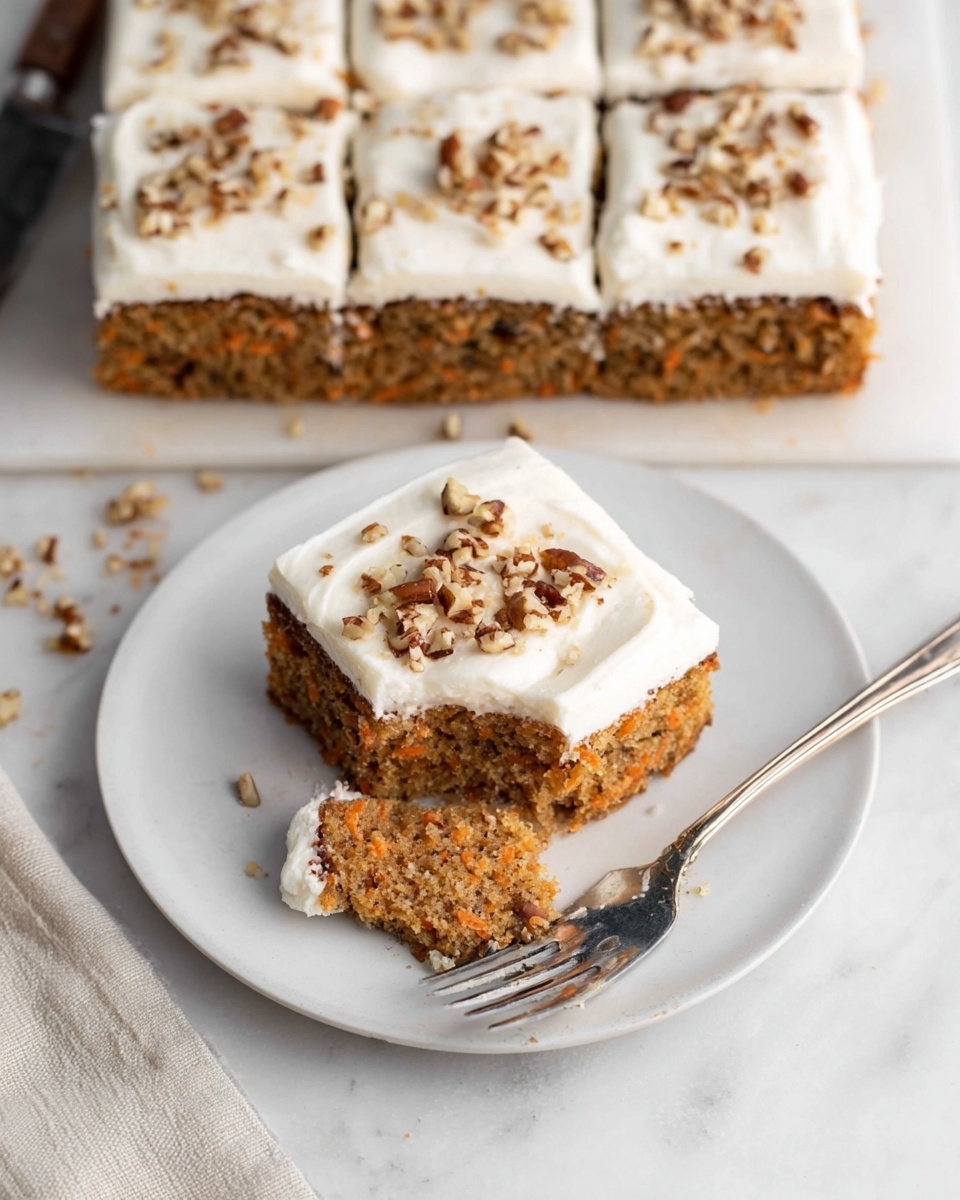 Single white plate featuring a single square slice of moist carrot cake with a thick, creamy layer of white frosting on top, sprinkled with chopped pecans, close-up angled shot that reveals the dense, textured interior filled with visible specks of grated carrot and chopped nuts, styled on a pristine white marble surface with natural lighting highlighting the soft crumb and rich frosting, intimate plated serving photo taken with an iphone --ar 4:5 --v 7