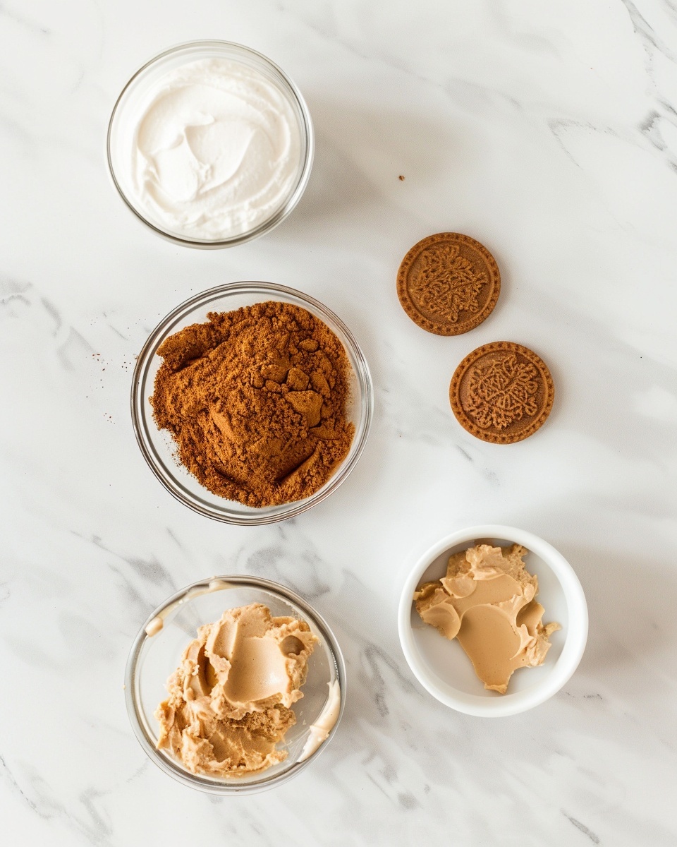 Single white glass serving filled with a creamy, smooth layered dessert featuring light beige mousse and visible thin layers of chocolate pieces and crunchy crumbled cookies in the middle and on top, close-up angled shot highlighting the silky texture and crumbly topping, placed on a white marble surface with soft natural lighting, styled like an intimate food blog presentation ready to enjoy, photo taken with an iphone --ar 4:5 --v 7