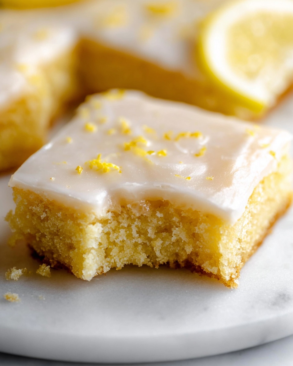 Large white rectangular baking pan filled with an uncut batch of moist lemon bars topped with a smooth, glossy lemon glaze sprinkled with fresh lemon zest, arranged evenly and showcasing the bright yellow, tender crumb beneath the icing, set on a white marble countertop with natural light highlighting the glossy texture and vibrant colors, professional food magazine hero shot photo taken with an iphone --ar 4:5 --v 7