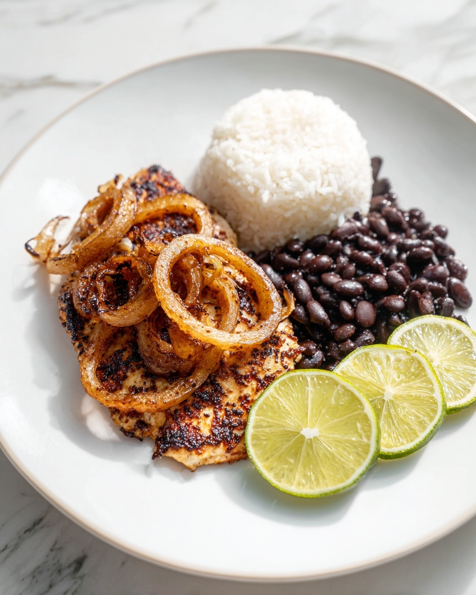 Large white serving platter showcasing a full tray of perfectly seasoned, pan-seared chicken thighs topped with caramelized golden onions, accompanied by a generous portion of fluffy white rice and rich black beans, garnished with fresh lime wedges on the side, whole dish displayed on a white marble countertop with natural lighting, professional food magazine hero shot photo taken with an iphone --ar 4:5 --v 7