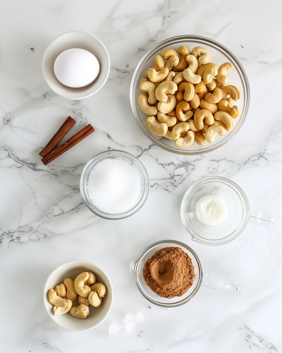 Sweet and Crunchy Candied Cashews Made Easy at Home Recipe 5 Single white bowl filled with a modest serving of cinnamon sugar-coated cashew nuts, close-up angle revealing the crystalline sugar texture sparkling on each nut’s curved surface, highlighting the golden-brown roasted exterior, placed on a white marble background with natural lighting, styled as an inviting individual portion ready to eat, intimate plated serving photo taken with an iphone --ar 4:5 --v 7